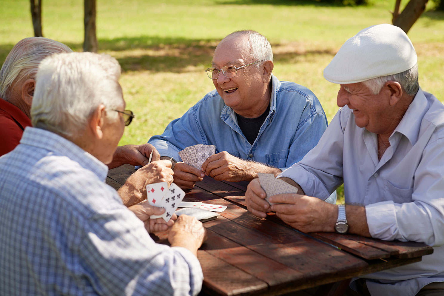 Residents at The Estates playing cards outside